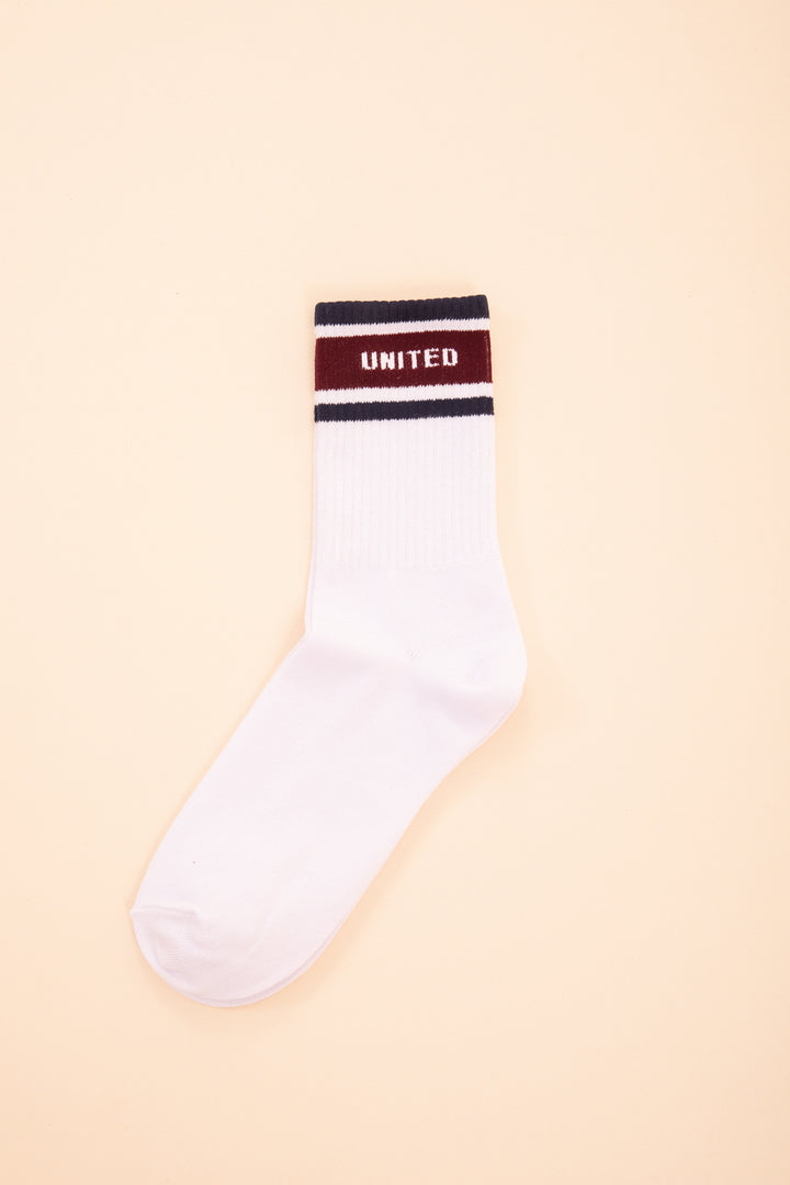 Chaussette blanche LYOUM avec United écrit en haut.