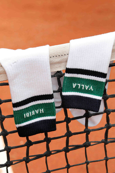 Chaussettes blanches mi-hautes avec rayures navy et vert et signature LYOUM 'Yalla' tricoté sur un côté et 'Habibi' de l'autre.