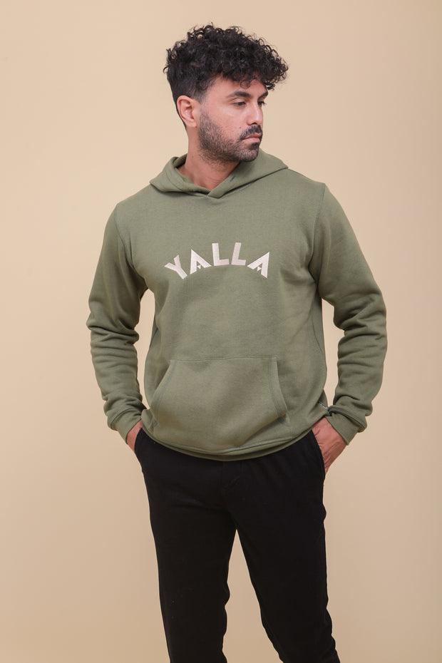 Pièce iconique, le hoodie pour homme by LYOUM, en molleton épais et gratté, de couleur vert kaki. Coupe parfaite. Broderie 'Yalla' sur le devant, en fil beige clair.