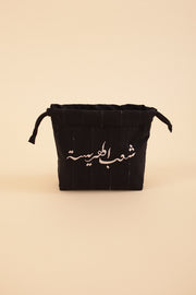 Pochette à cordant avec broderie 'Peuple de la Harissa' en arabe sur un côté. La petite trousse idéale et pratique à emporter partout.