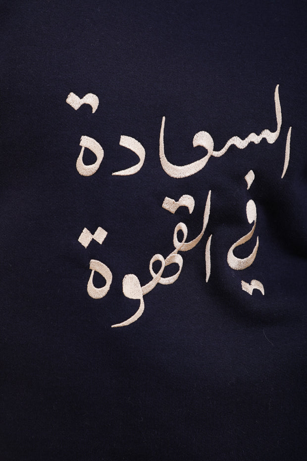 Broderie 'Le Bonheur est dans le Café' en calligraphie arabe.