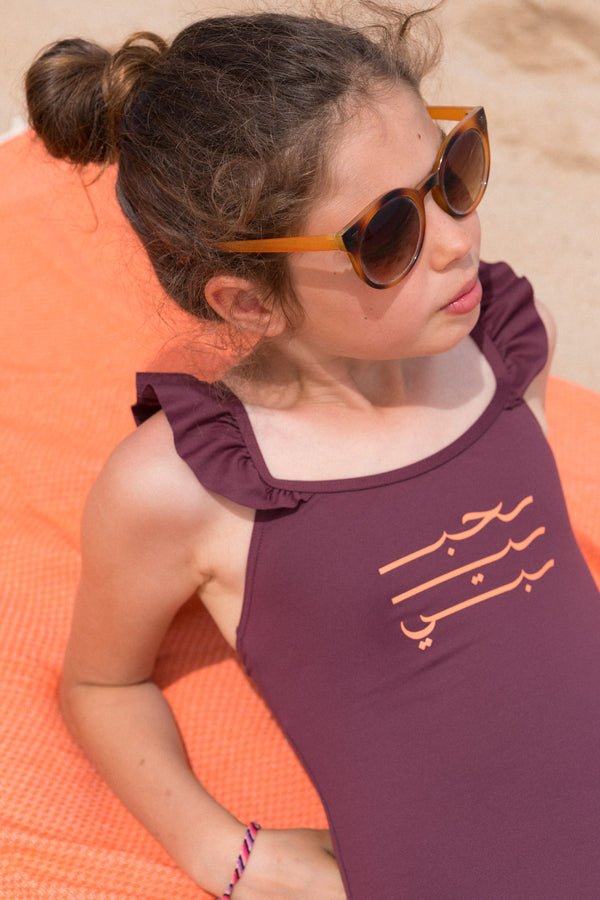 Maillot une-pièce LYOUM pour enfant, adorable et confortable. Calligraphie Habibi en arabe sur le devant. Photo de face.